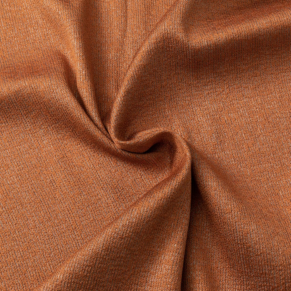Detail van oranje stof met glans en plooien.