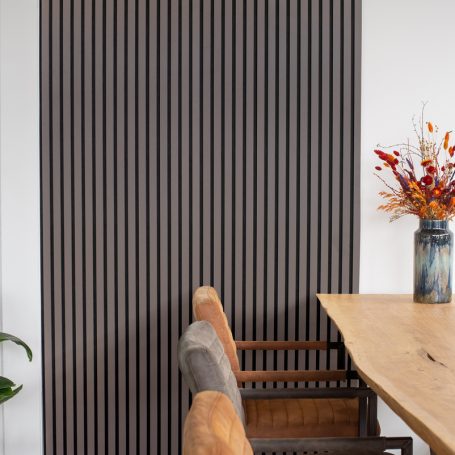Lamellenwand naast een eettafel.