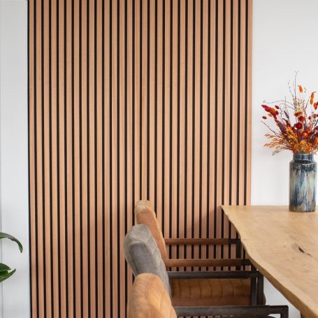 Lamellenwand naast een eettafel.