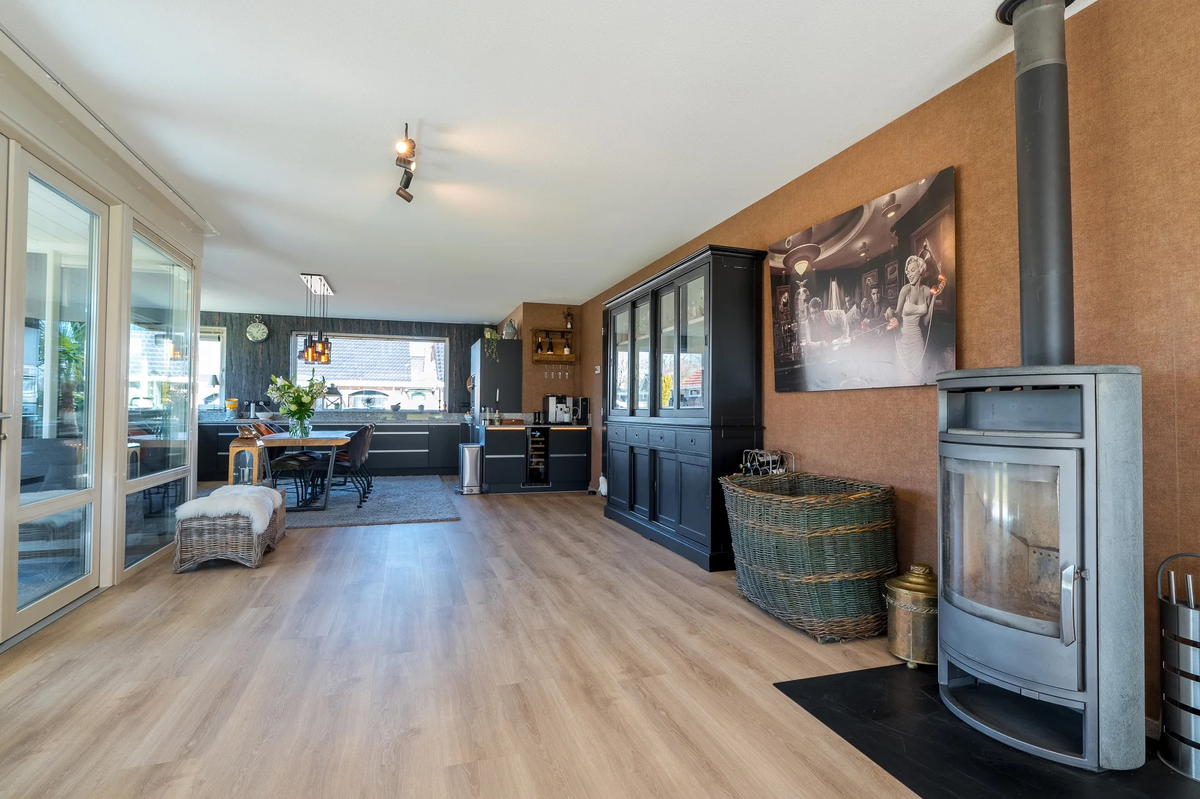 Ruim overzicht van de houtlookvloer van woonkamer naar keuken in Westerbork