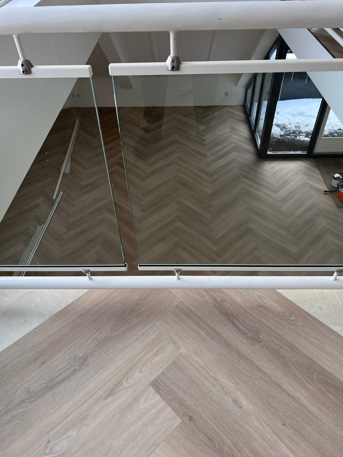 Visgraatpatroon op beide niveaus gezien door de glasbalustrade in Zuidlaren